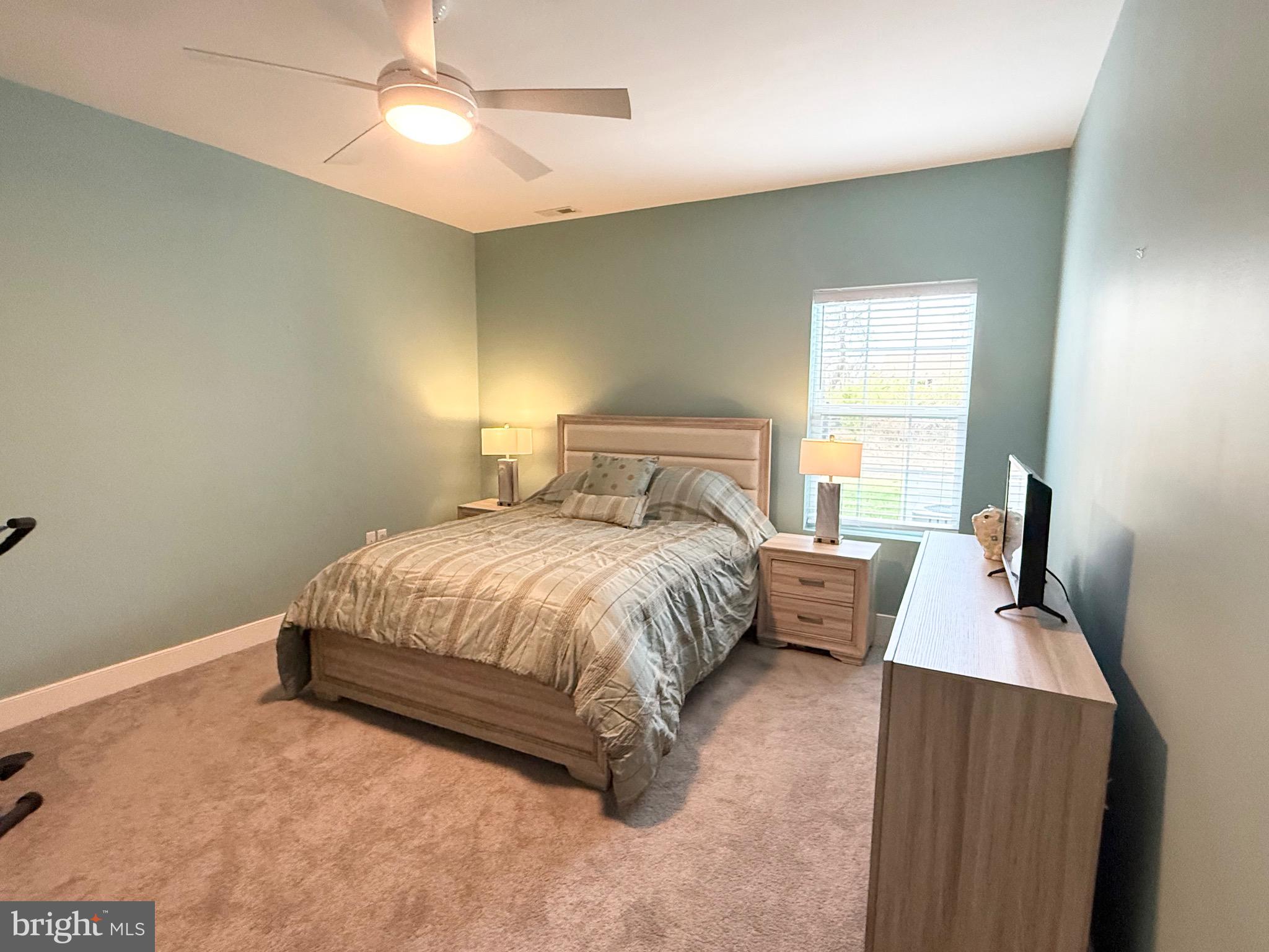30609 Cedar Neck Road, Unit 3103 Ocean View, DE 19970 - Photo 21 of 39 a bed room with a bed and a window
