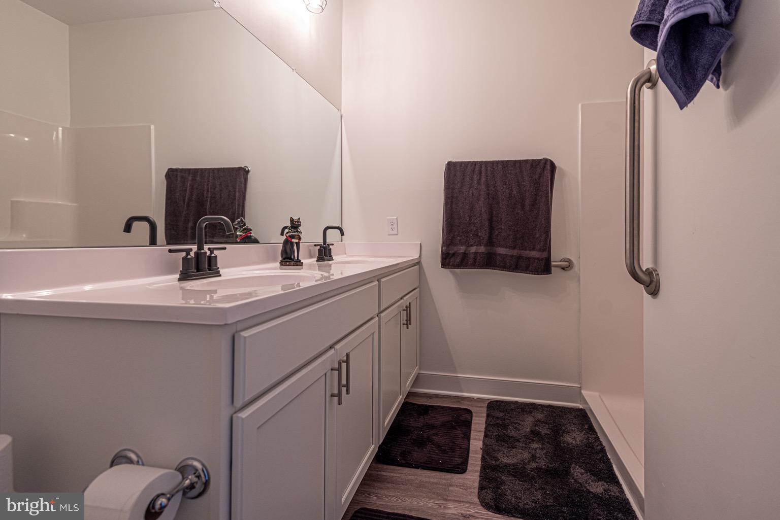 30609 Cedar Neck Road, Unit 3103 Ocean View, DE 19970 - Photo 22 of 39 a bathroom with a sink and a mirror