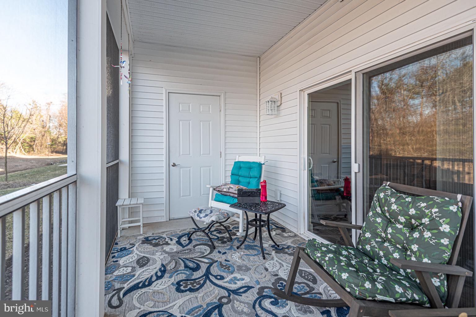 30609 Cedar Neck Road, Unit 3103 Ocean View, DE 19970 - Photo 29 of 39 a view of a porch with chairs and backyard