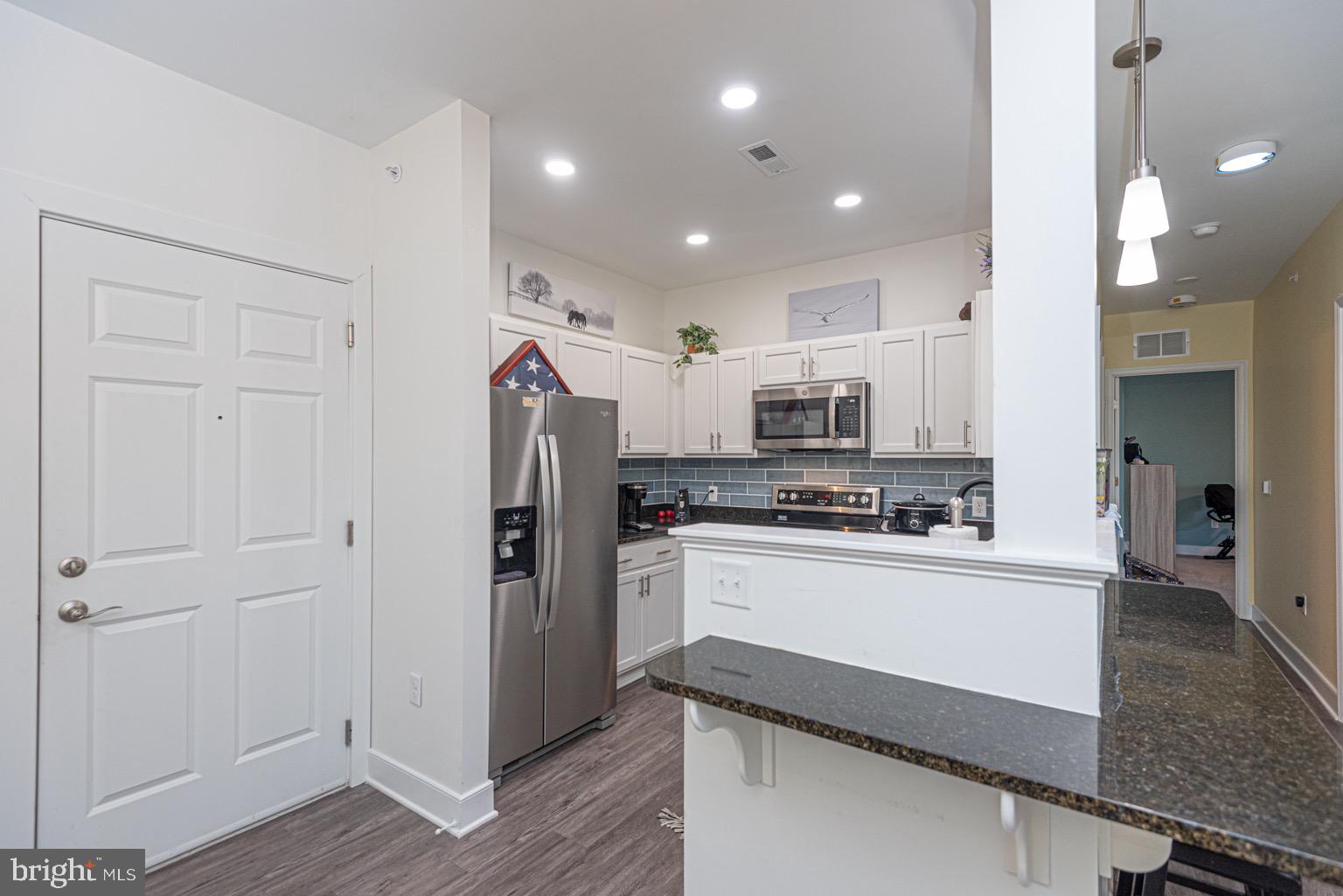30609 Cedar Neck Road, Unit 3103 Ocean View, DE 19970 - Photo 6 of 39 a kitchen with refrigerator and cabinets