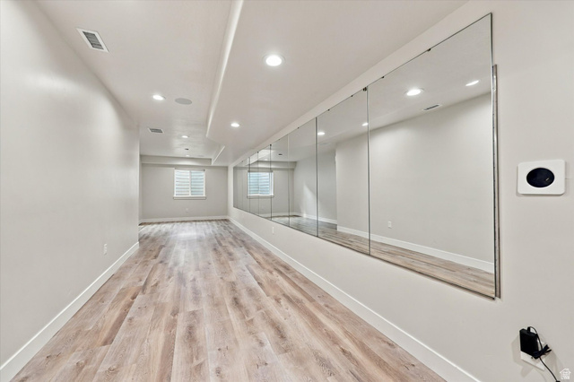 754 West 400 North Mapleton, UT 84664 - Photo 65 of 86 Spacious room featuring wood-finish flooring, recessed lighting, a wall-mounted mirror installation, and a window.