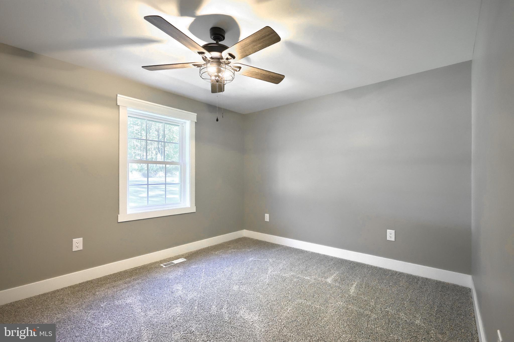 10 Echo Trail Fairfield, PA 17320 - Photo 29 of 43 an empty room with a chandelier fan and windows