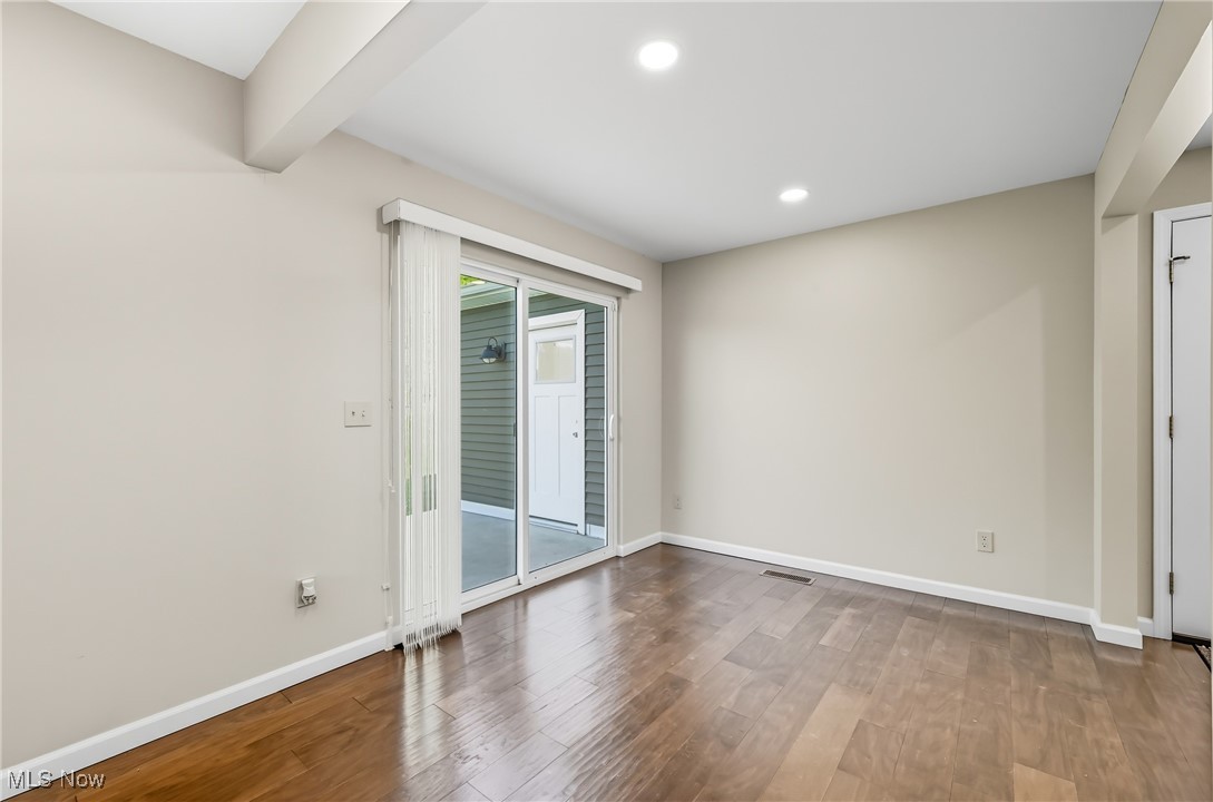 6264 Herbert Road Canfield, OH 44406 - Photo 11 of 47 Empty room with wood finished floors, recessed lighting, and beam ceiling