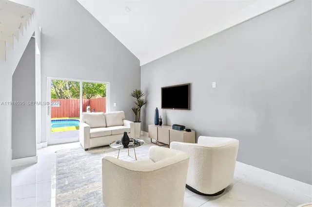 a view of dining table a sink and cabinets in a room