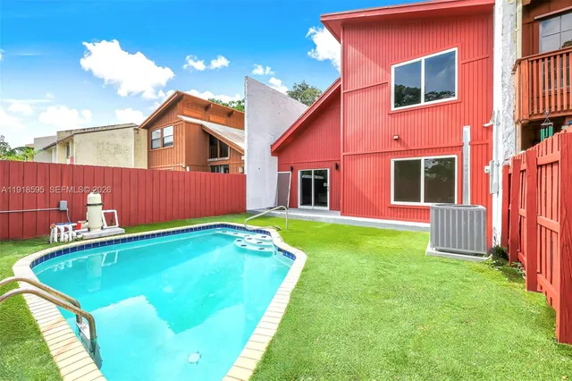 an aerial view of a houses with a yard