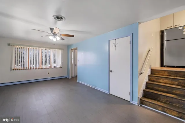 a bedroom with a bed and a large mirror