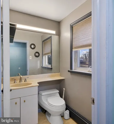 a view of a hallway with wooden floor and closet