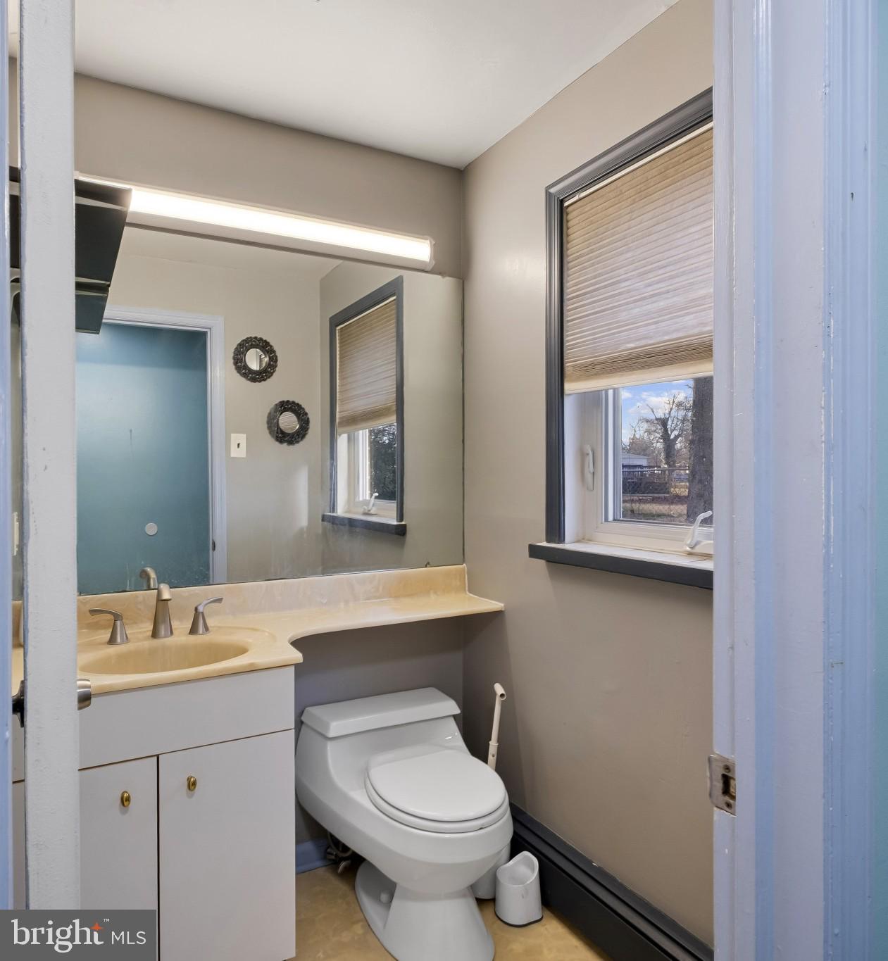 804 Sunset Terrace Dover, DE 19904 - Photo 16 of 33 a bathroom with a toilet a sink and mirror