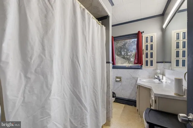 a bedroom with bed and wooden floor