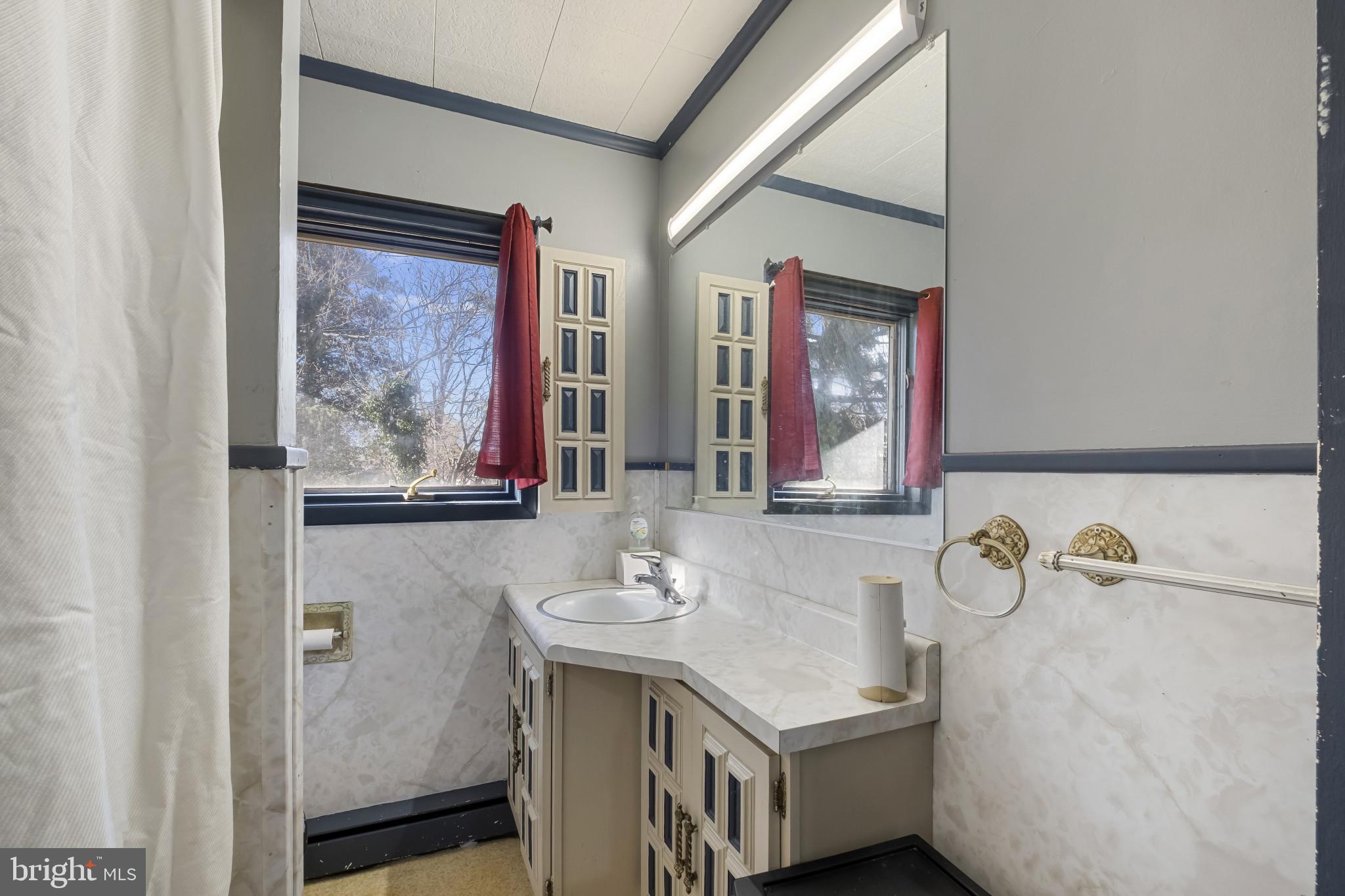 804 Sunset Terrace Dover, DE 19904 - Photo 21 of 33 a bathroom with a granite countertop sink a mirror and a shower