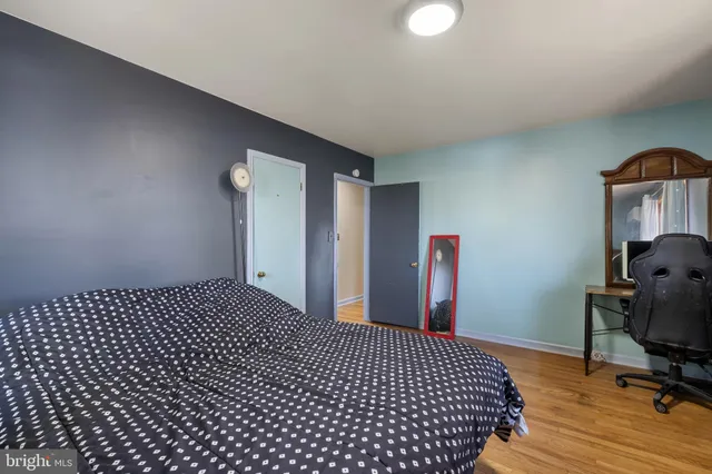a bedroom with a bed window and dresser