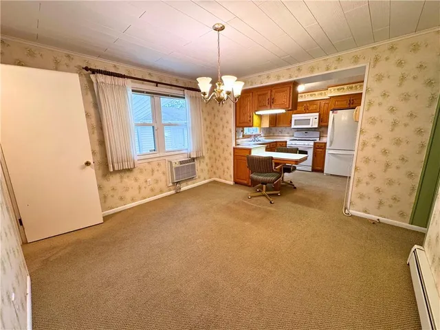 a kitchen with a sink a stove a refrigerator and a microwave