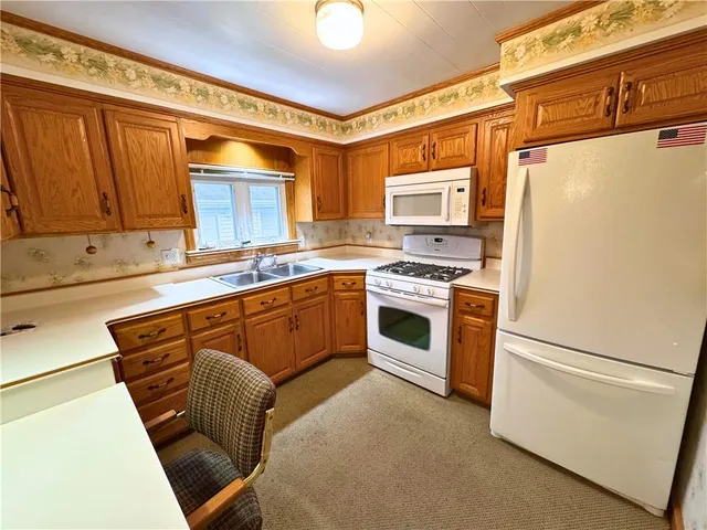 a kitchen with a sink dining table and chairs