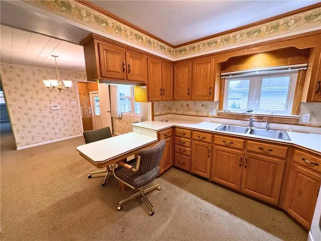 an empty room with windows and closet area