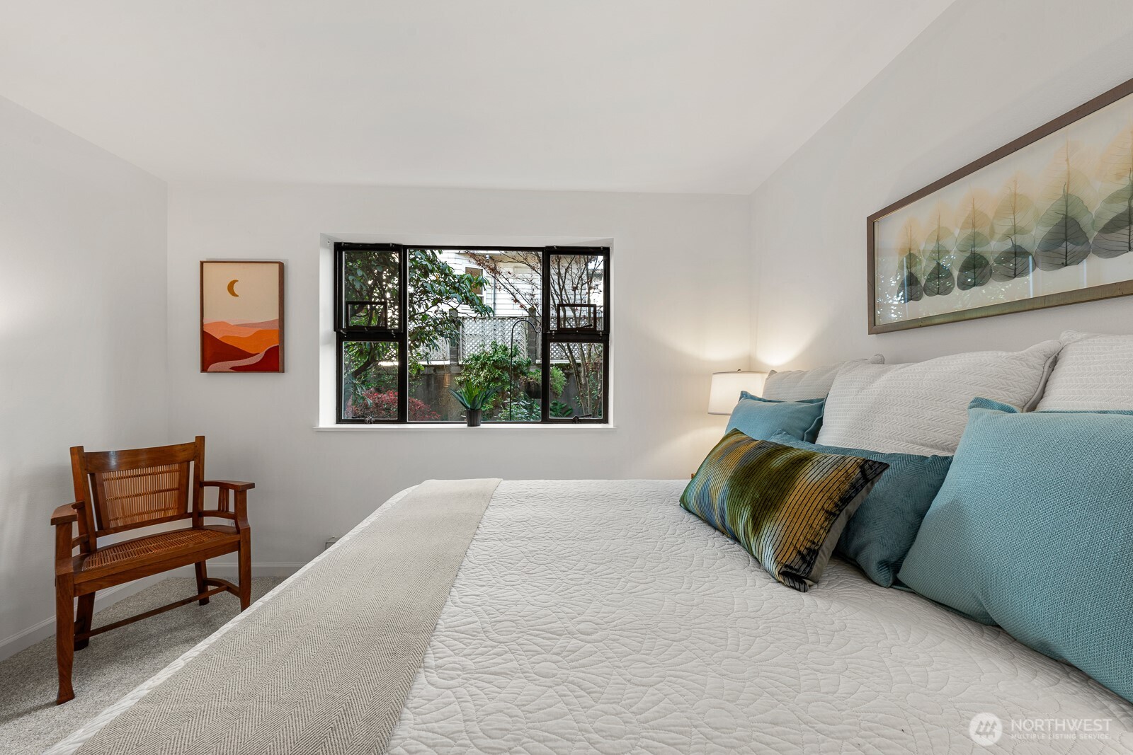 912 3rd Avenue West, Unit 101 Seattle, WA 98119 - Photo 12 of 25 a bedroom with a bed and a painting on the wall