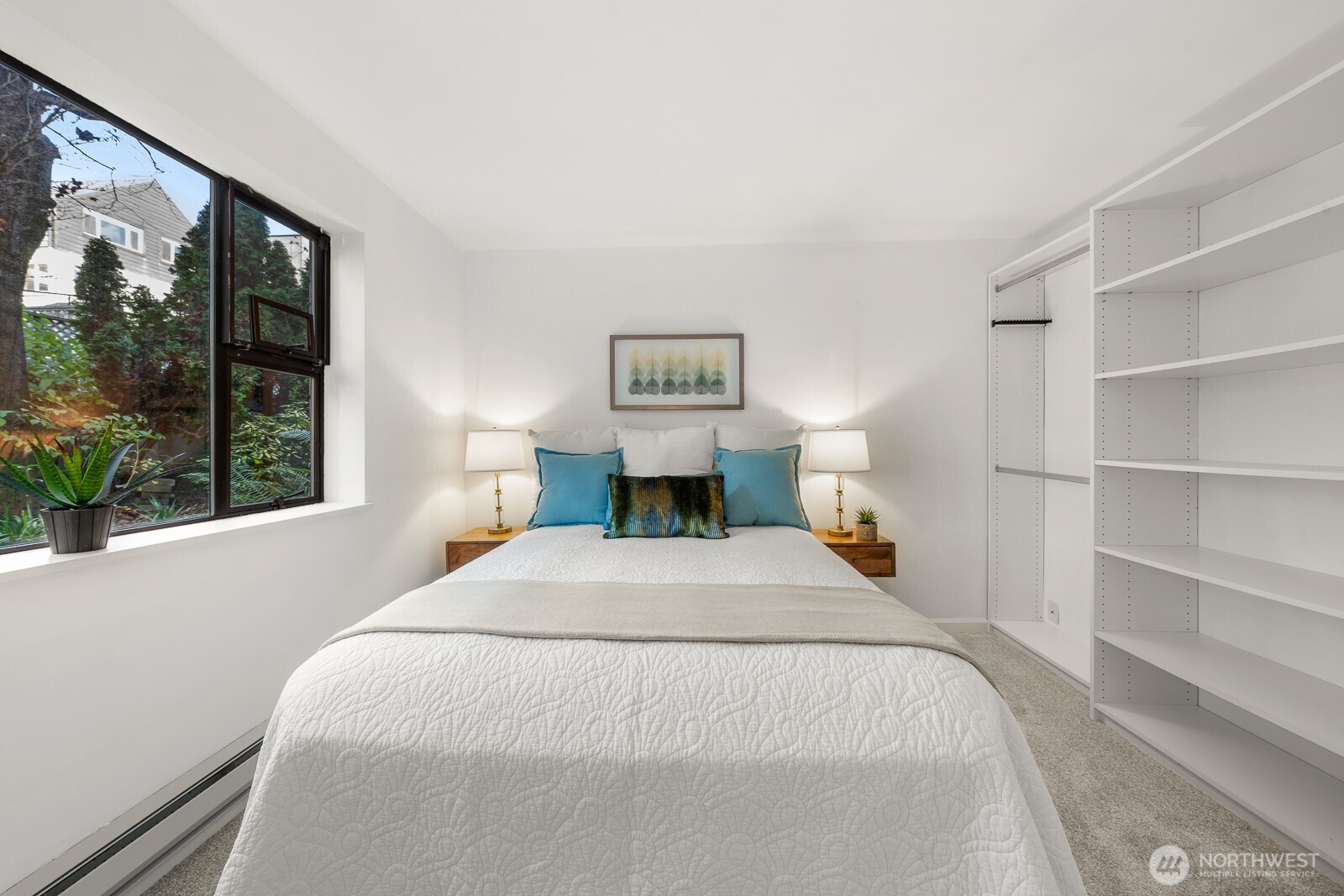 912 3rd Avenue West, Unit 101 Seattle, WA 98119 - Photo 13 of 25 a bedroom with a large bed and a large window