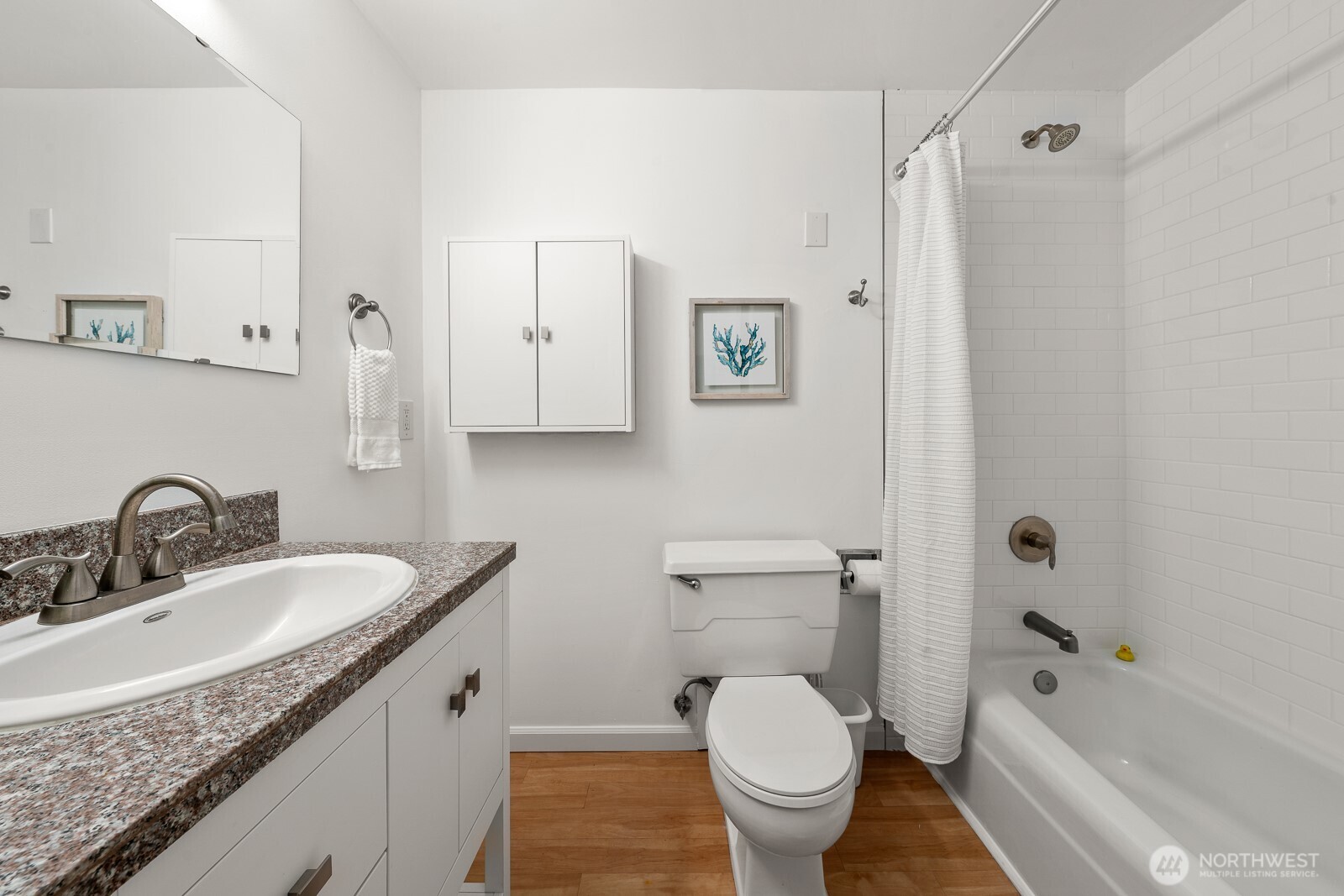 912 3rd Avenue West, Unit 101 Seattle, WA 98119 - Photo 15 of 25 a bathroom with a granite countertop sink toilet and shower