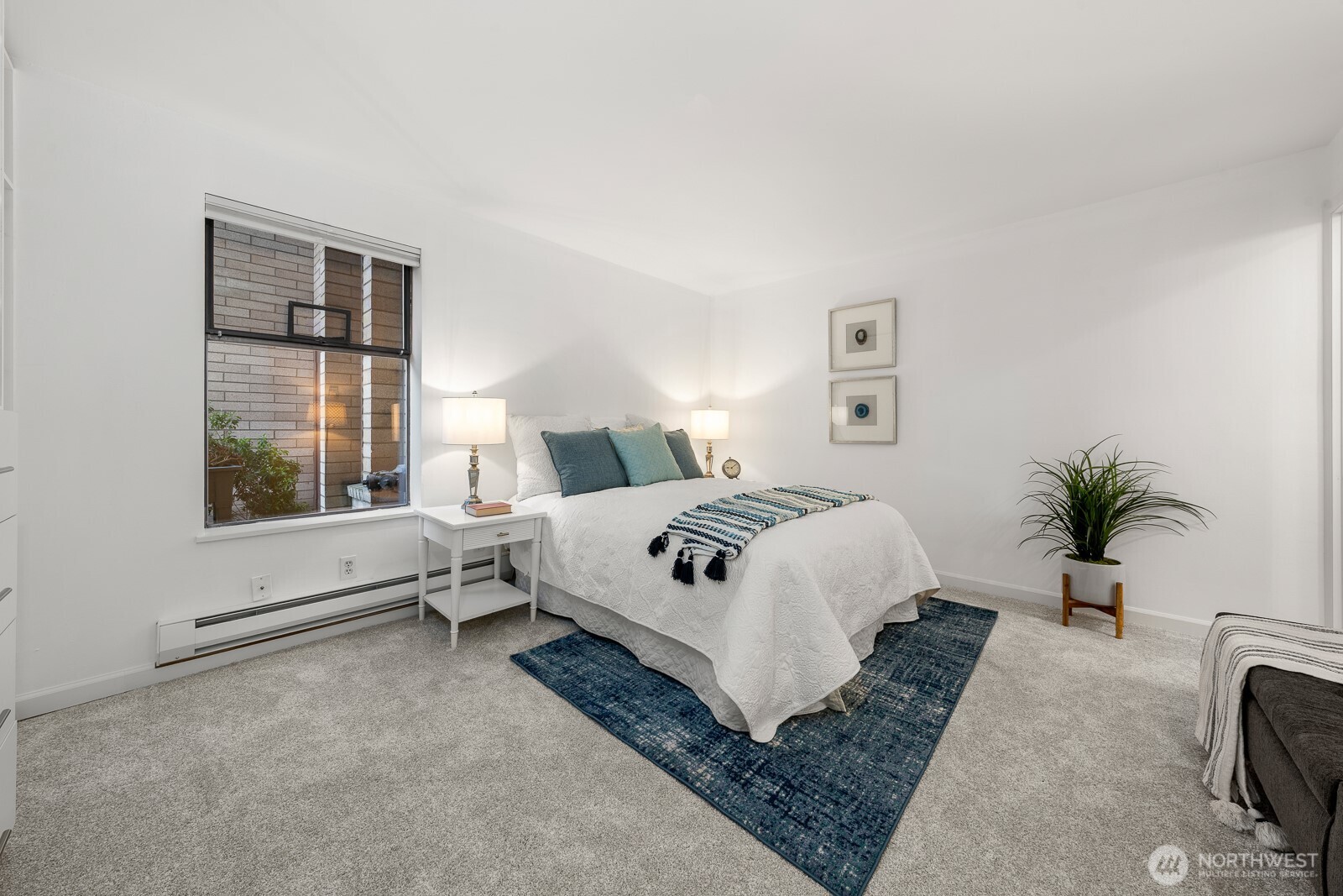 912 3rd Avenue West, Unit 101 Seattle, WA 98119 - Photo 16 of 25 a bedroom with a large bed and a window