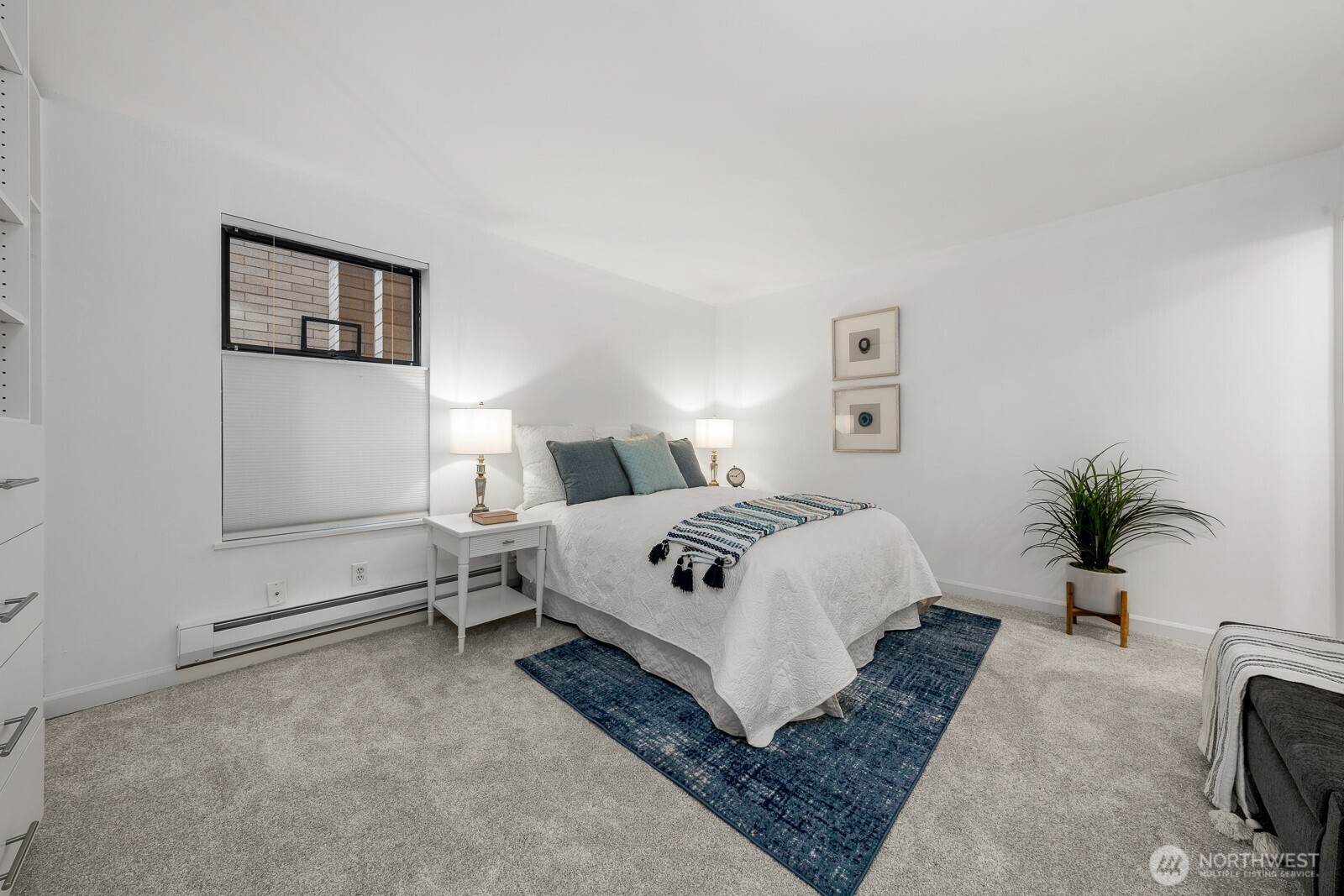 912 3rd Avenue West, Unit 101 Seattle, WA 98119 - Photo 17 of 25 a bedroom with a large bed and a couch
