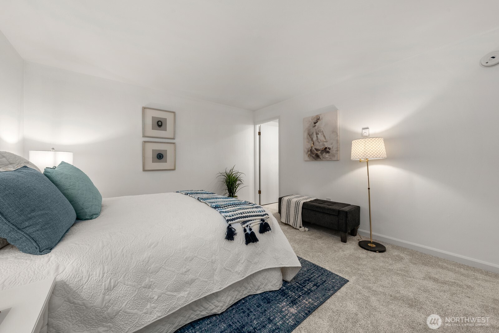 912 3rd Avenue West, Unit 101 Seattle, WA 98119 - Photo 18 of 25 a bed room with a bed a couch and a chandelier