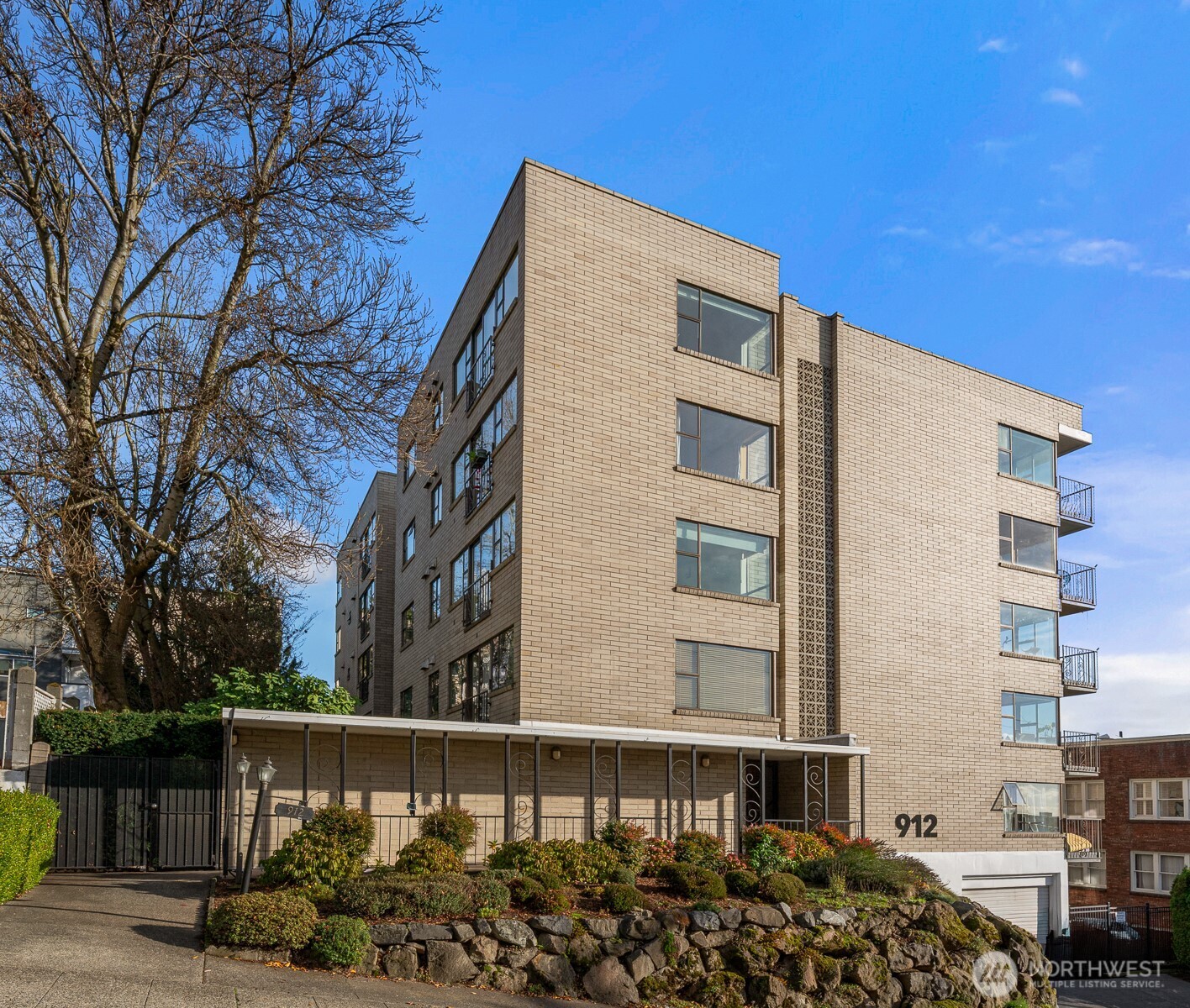912 3rd Avenue West, Unit 101 Seattle, WA 98119 - Photo 25 of 25 a front view of a building with a garden