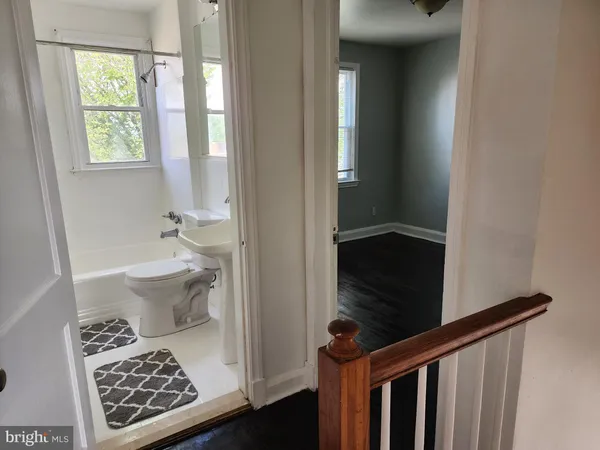 a bathroom with a toilet a sink and a window