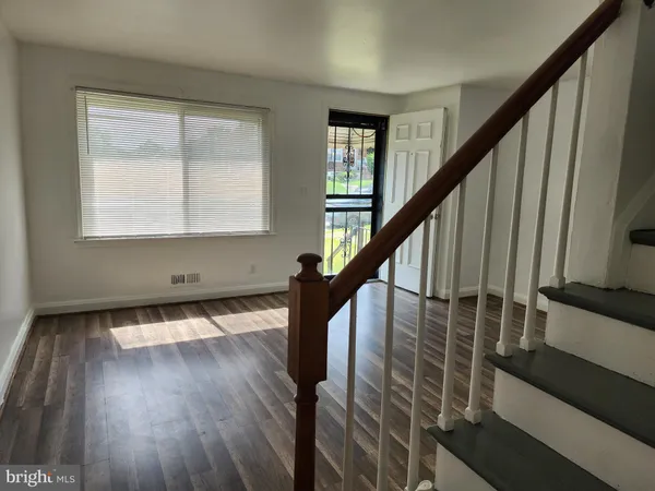 a view of entryway with wooden floor and stairs
