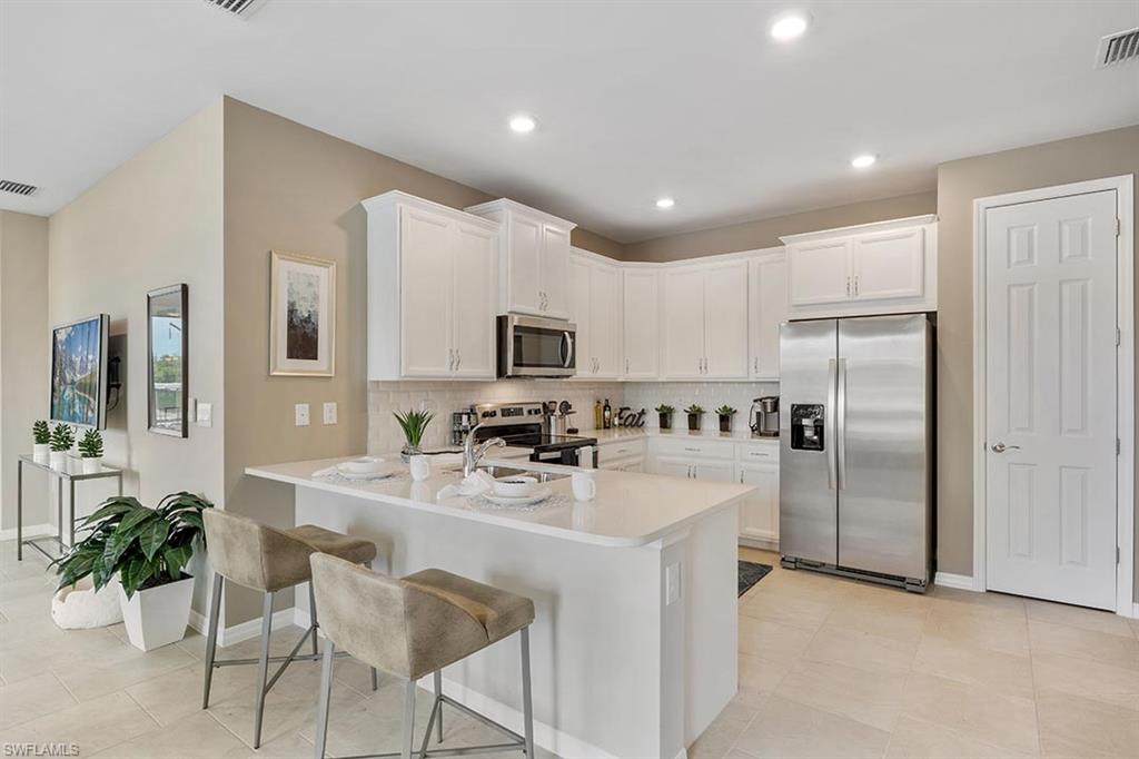 854 Enbrook Loop Naples, FL 34114 - Photo 6 of 18 a kitchen with counter space cabinets and appliances