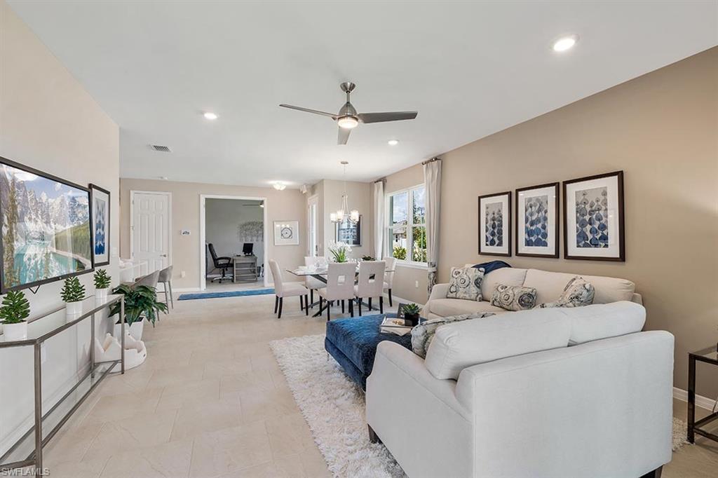 854 Enbrook Loop Naples, FL 34114 - Photo 8 of 18 a living room with furniture and a flat screen tv