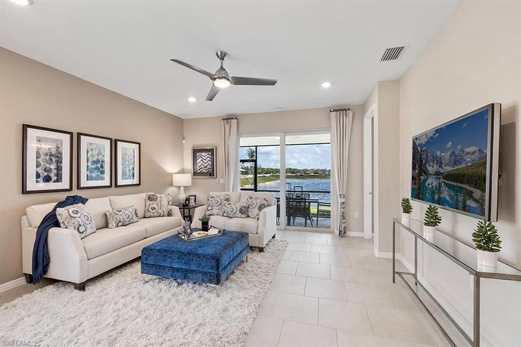 854 Enbrook Loop Naples, FL 34114 - Photo 9 of 18 a living room with furniture and a flat screen tv