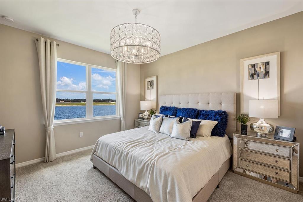 854 Enbrook Loop Naples, FL 34114 - Photo 10 of 18 a bedroom with a large bed and a chandelier