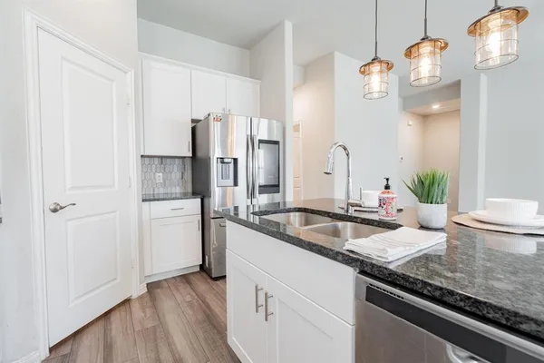 a kitchen with a sink and refrigerator