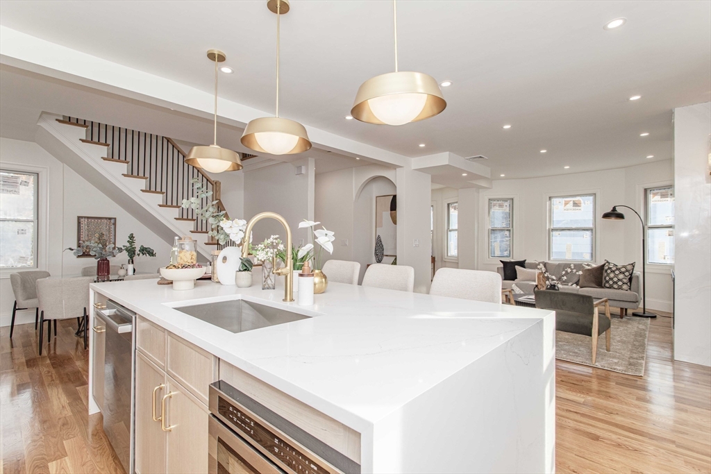 125 Mt Vernon Street, Unit 2 Newton, MA 02465 - Photo 10 of 36 a large kitchen with kitchen island a large island in it