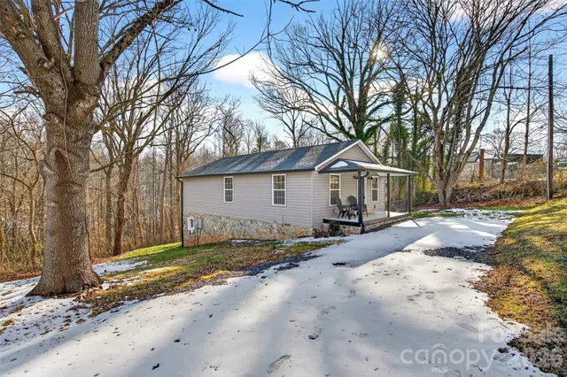 a view of a house with a yard covered in snow