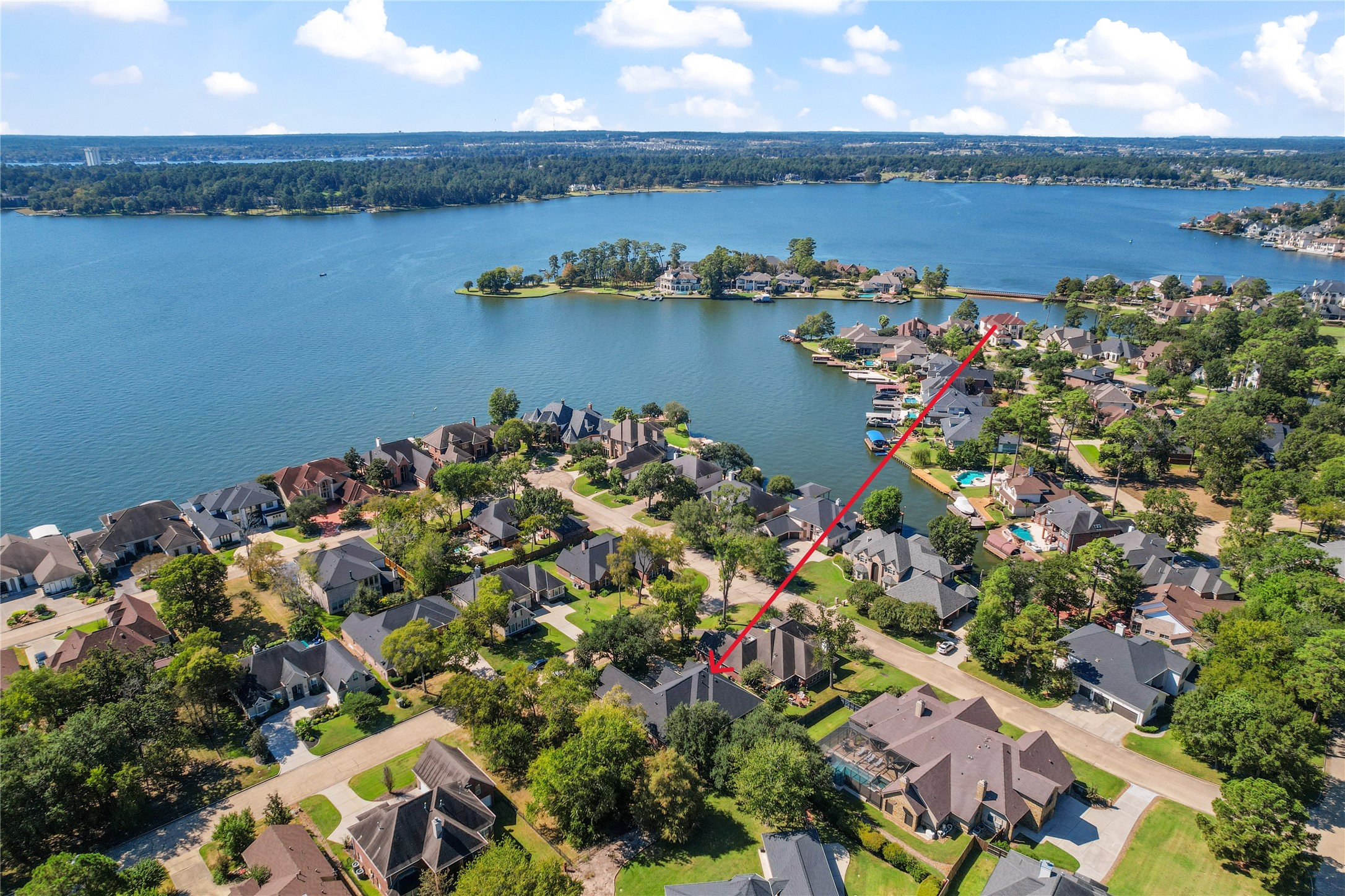 319 Palais Verde Road Montgomery, TX 77356 - Photo 3 of 40 This aerial photo showcases the charming residential neighborhood of Bentwater on Lake Conroe. The highlighted home is nestled among lush trees, offering a serene atmosphere with close proximity to the waterfront, providing scenic views water activities.