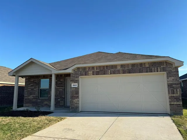 a front view of a house with a garage