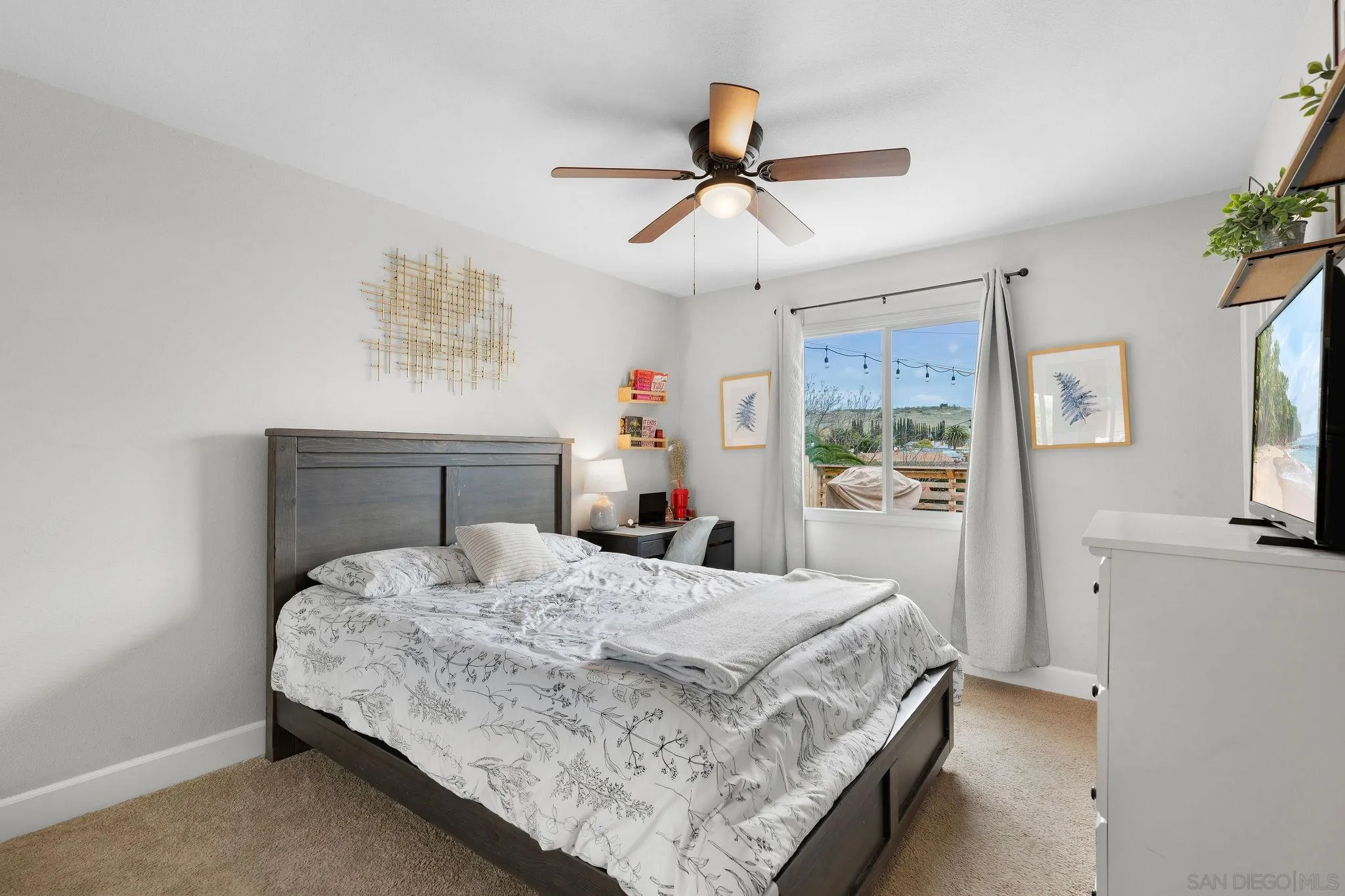 9735 Vomac Road Santee, CA 92071 - Photo 18 of 40 a bedroom with a bed and a chandelier