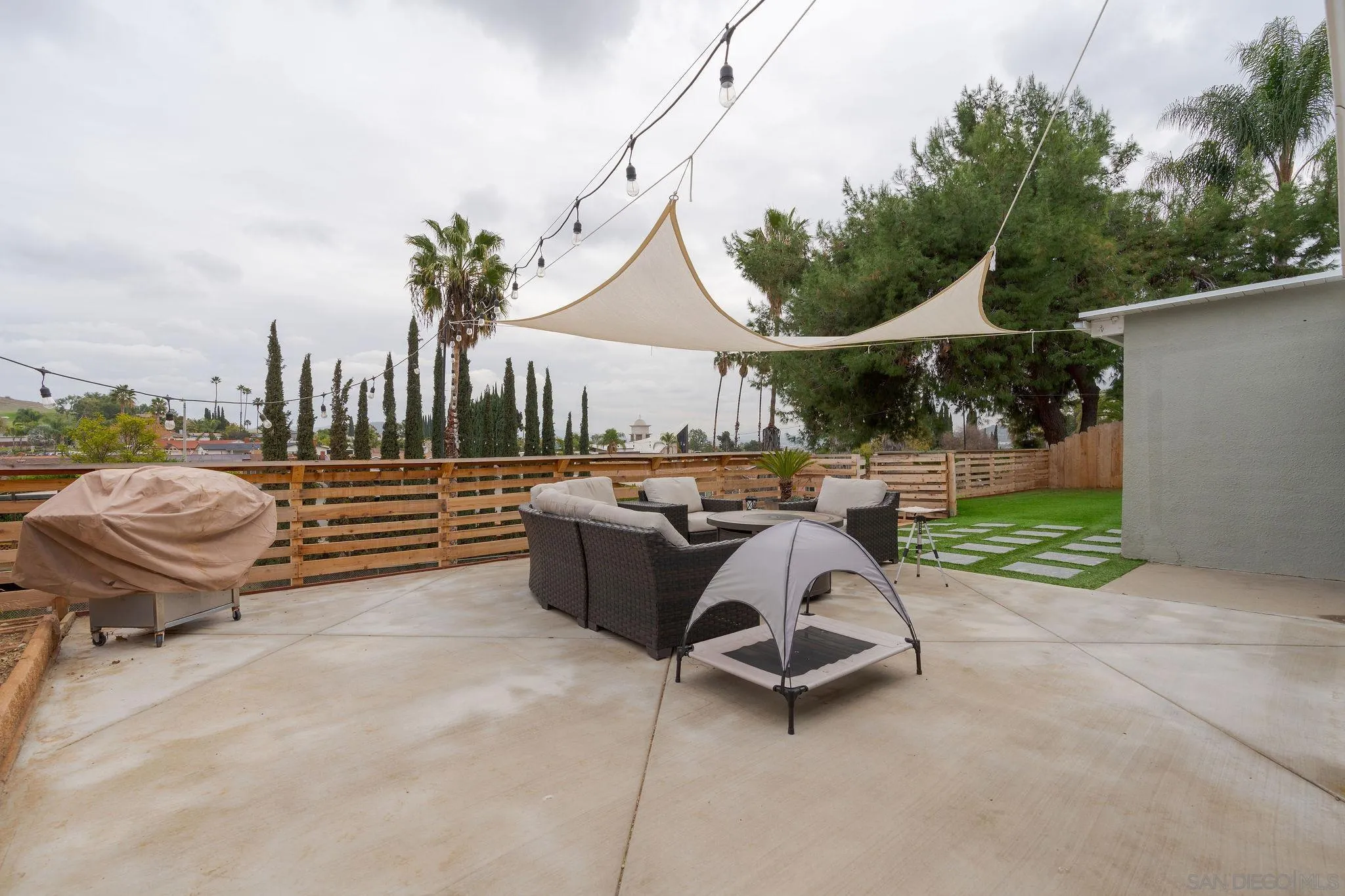 9735 Vomac Road Santee, CA 92071 - Photo 21 of 40 a view of a patio with table and chairs potted plants with wooden floor