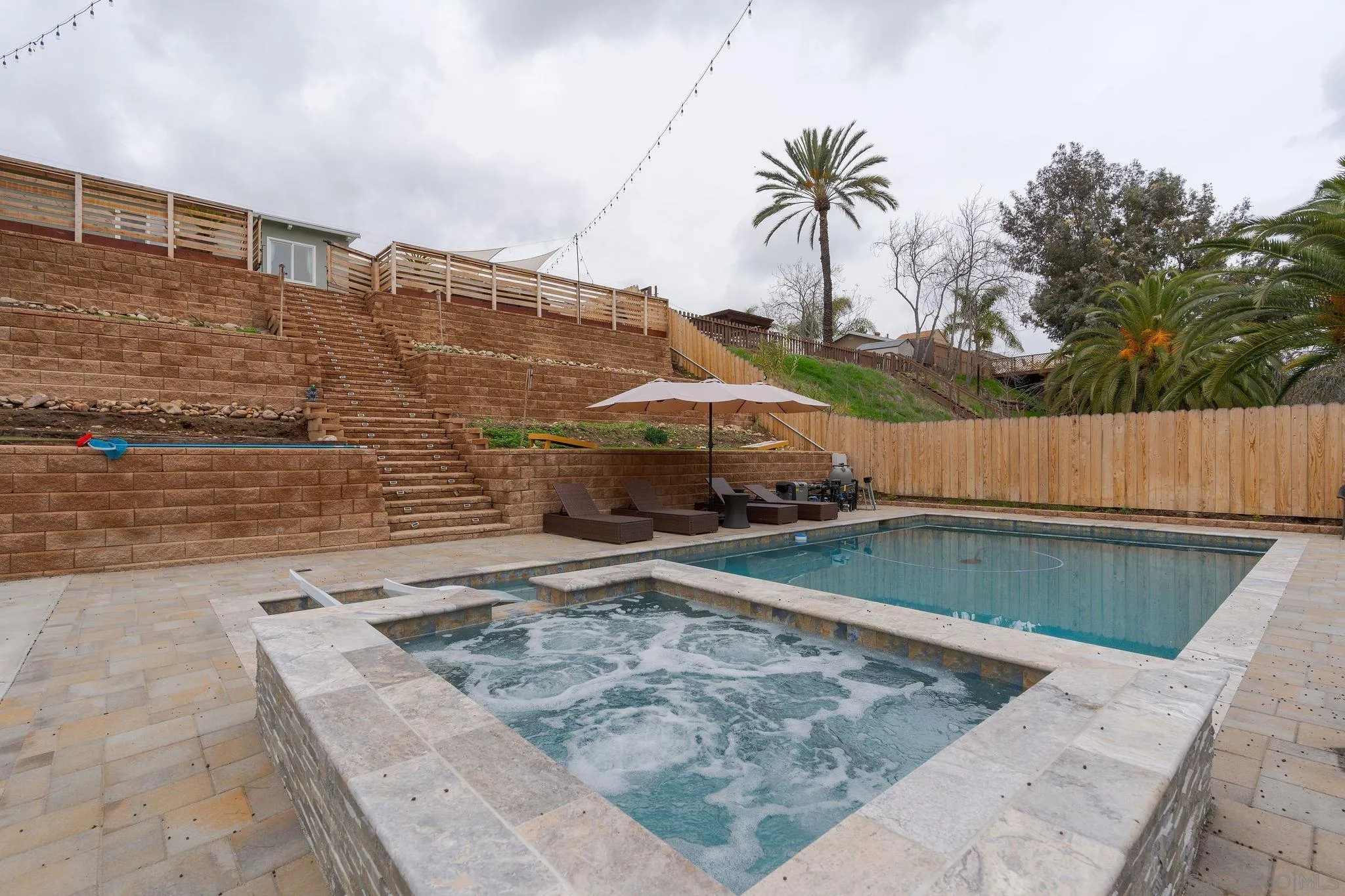 9735 Vomac Road Santee, CA 92071 - Photo 33 of 40 a view of a swimming pool with a patio