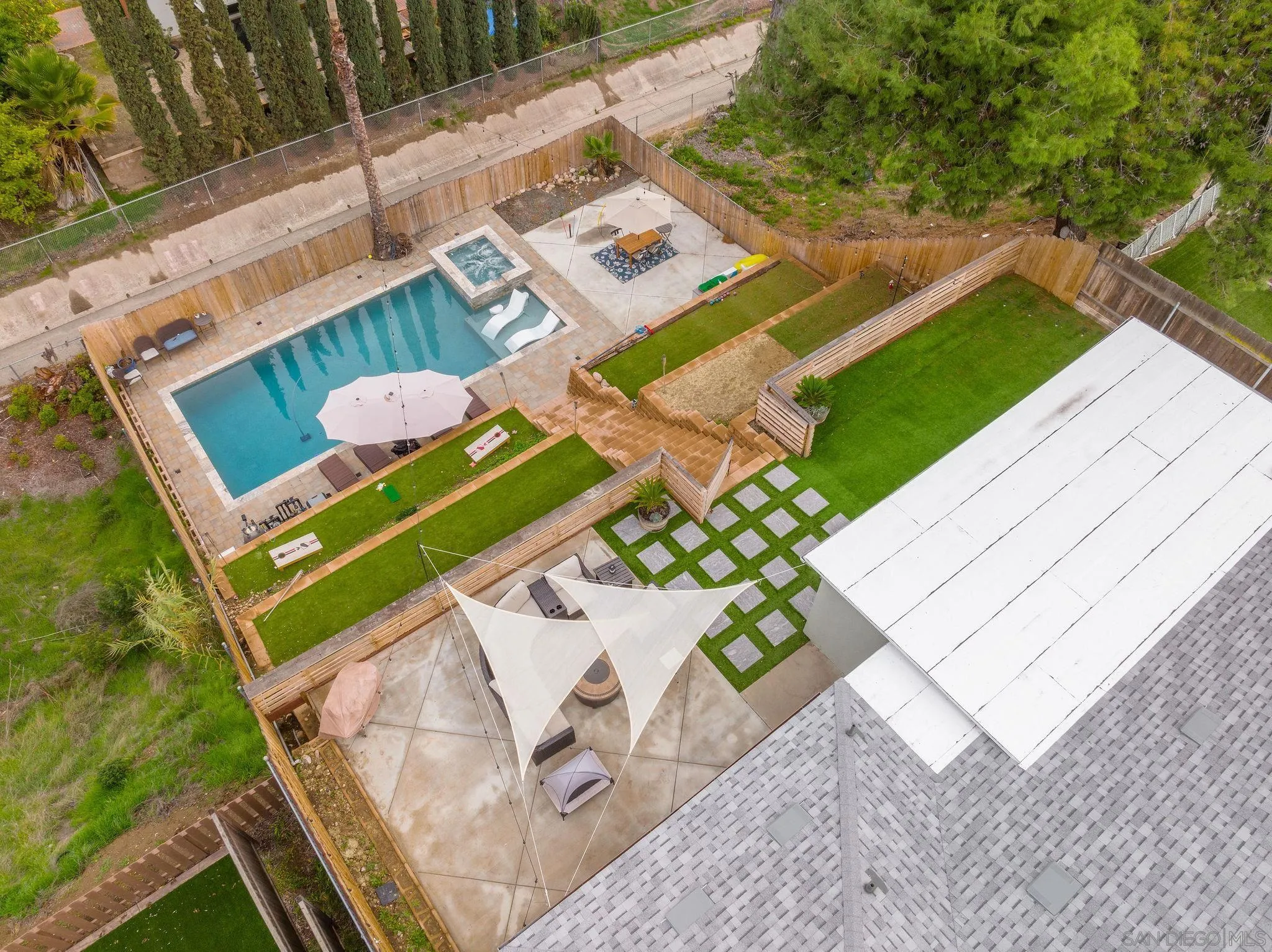 9735 Vomac Road Santee, CA 92071 - Photo 34 of 40 a view of a patio with table and chairs with wooden floor and fence