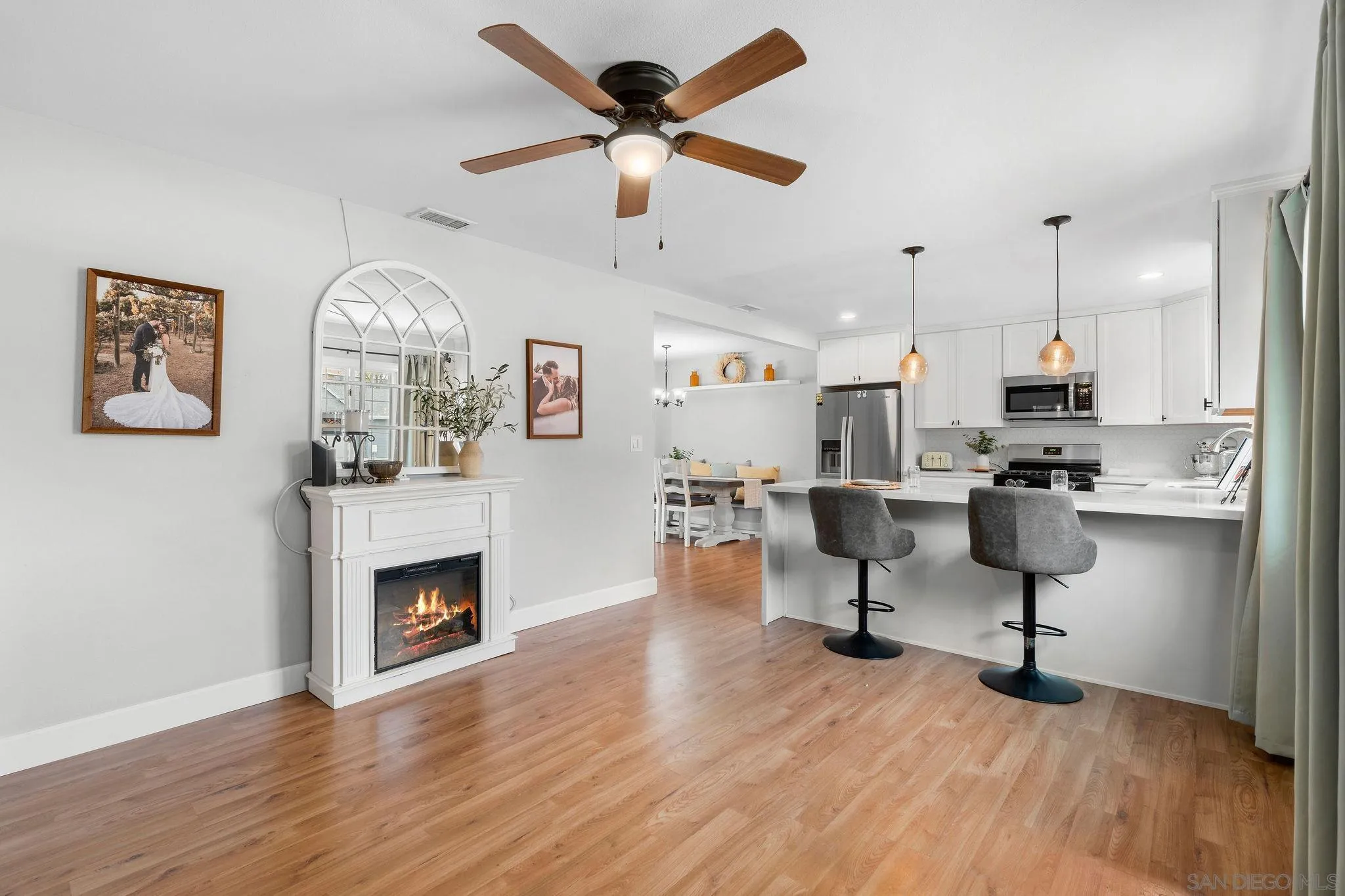 9735 Vomac Road Santee, CA 92071 - Photo 4 of 40 a living room with furniture and kitchen view
