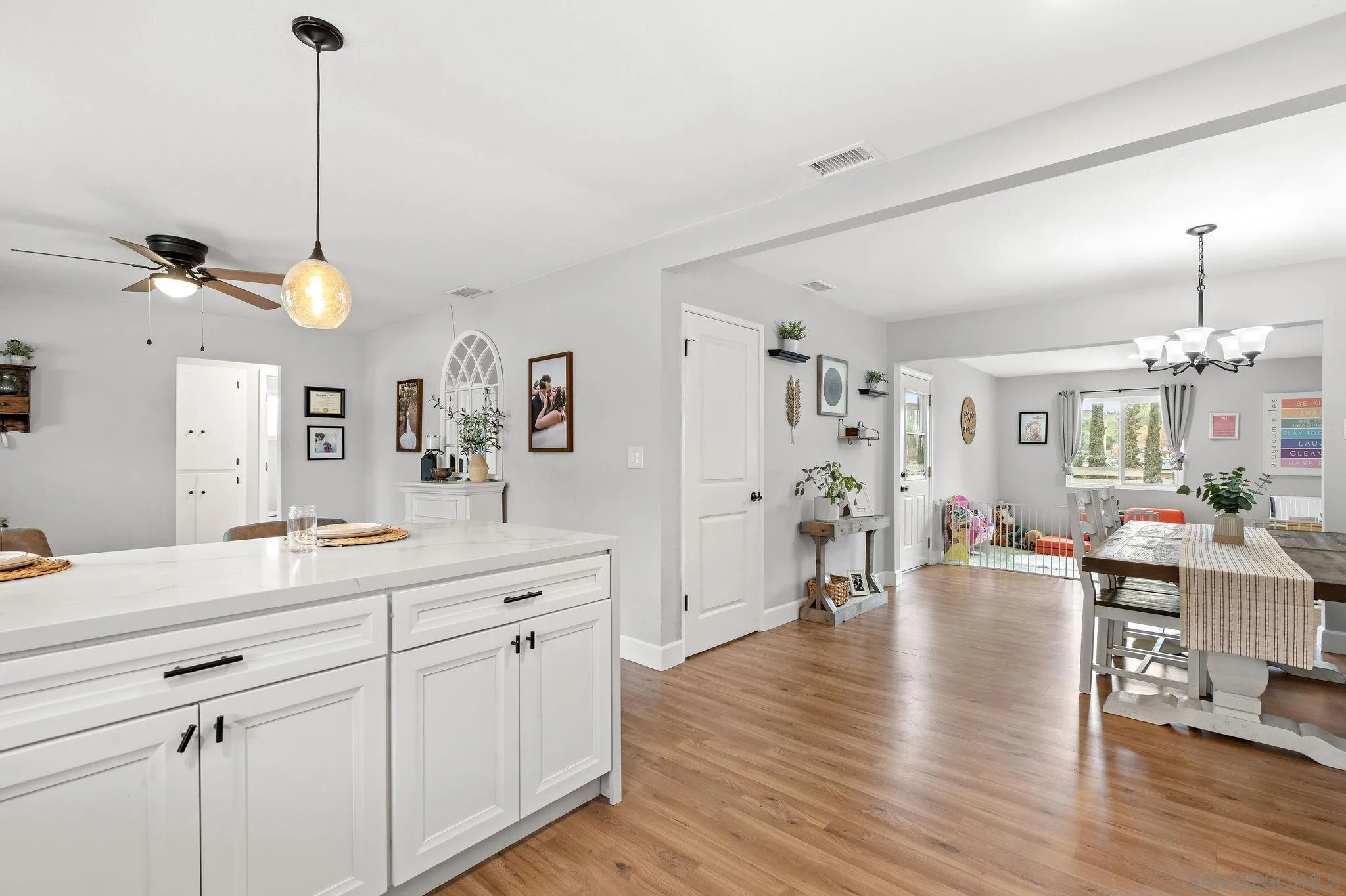 9735 Vomac Road Santee, CA 92071 - Photo 6 of 40 a living room with kitchen island furniture and a chandelier