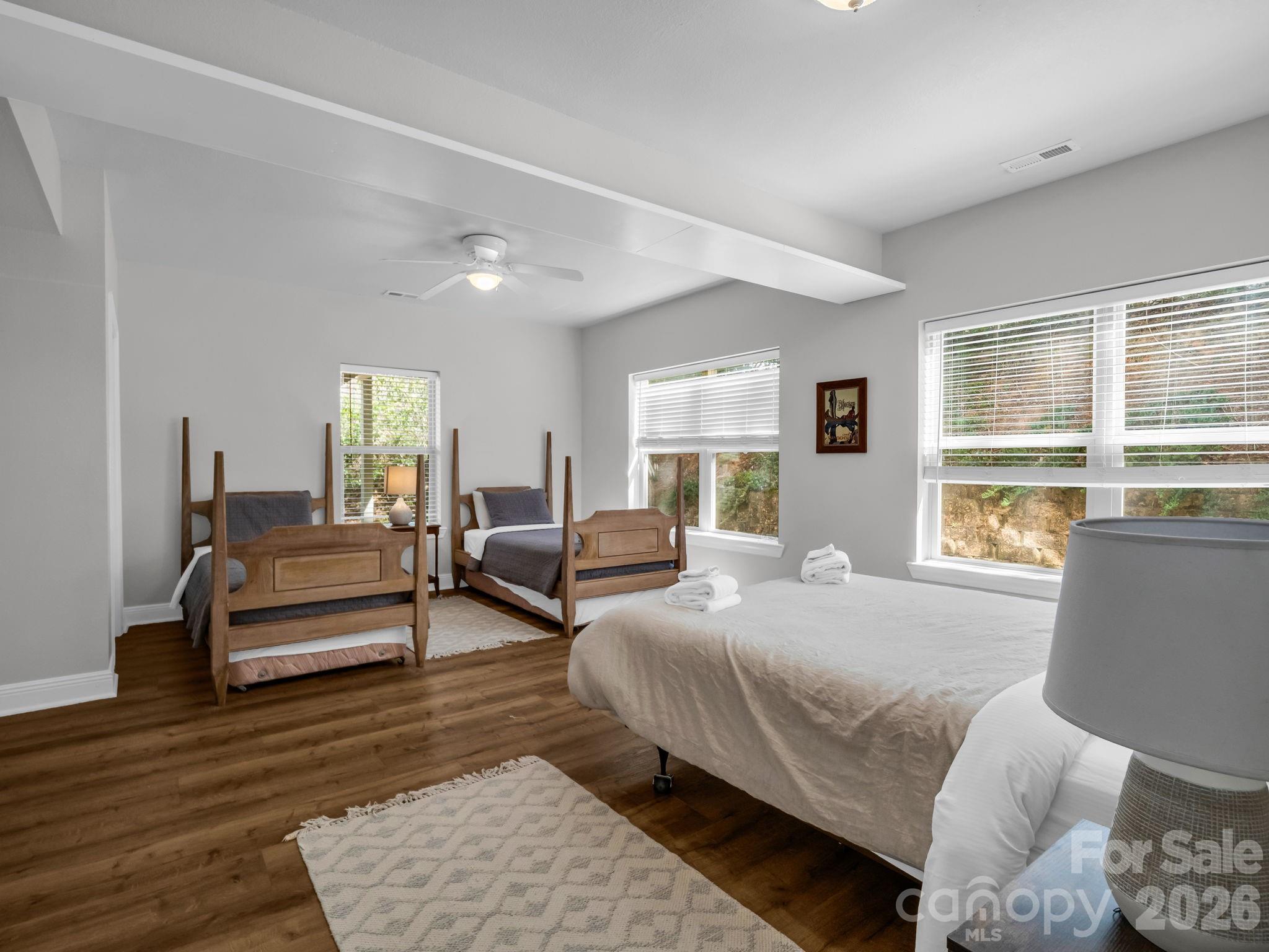 121 Fern Loop Lake Lure, NC 28746 - Photo 17 of 40 a bedroom with furniture and a large window
