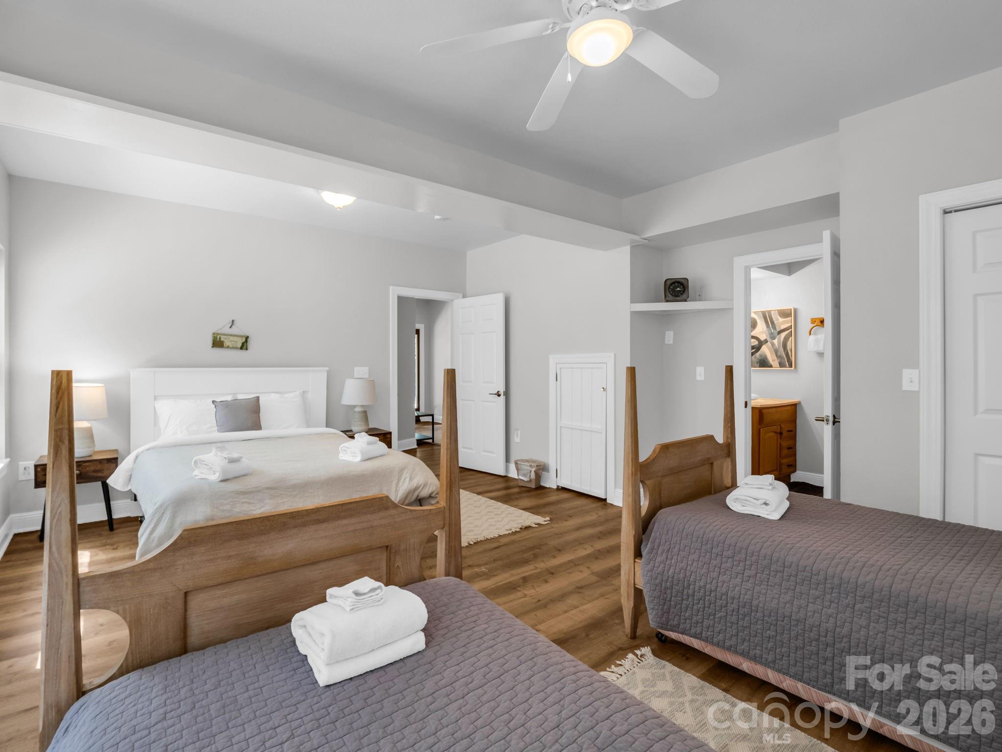 121 Fern Loop Lake Lure, NC 28746 - Photo 18 of 40 a bedroom with a bed and a chandelier