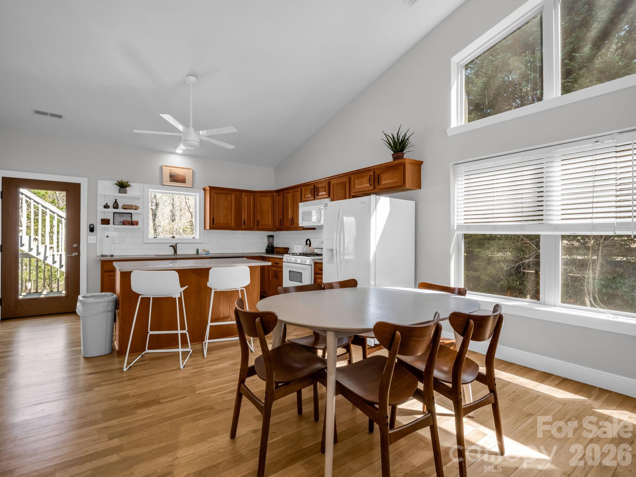 121 Fern Loop Lake Lure, NC 28746 - Photo 25 of 40 a view of a dining room with furniture and wooden floor