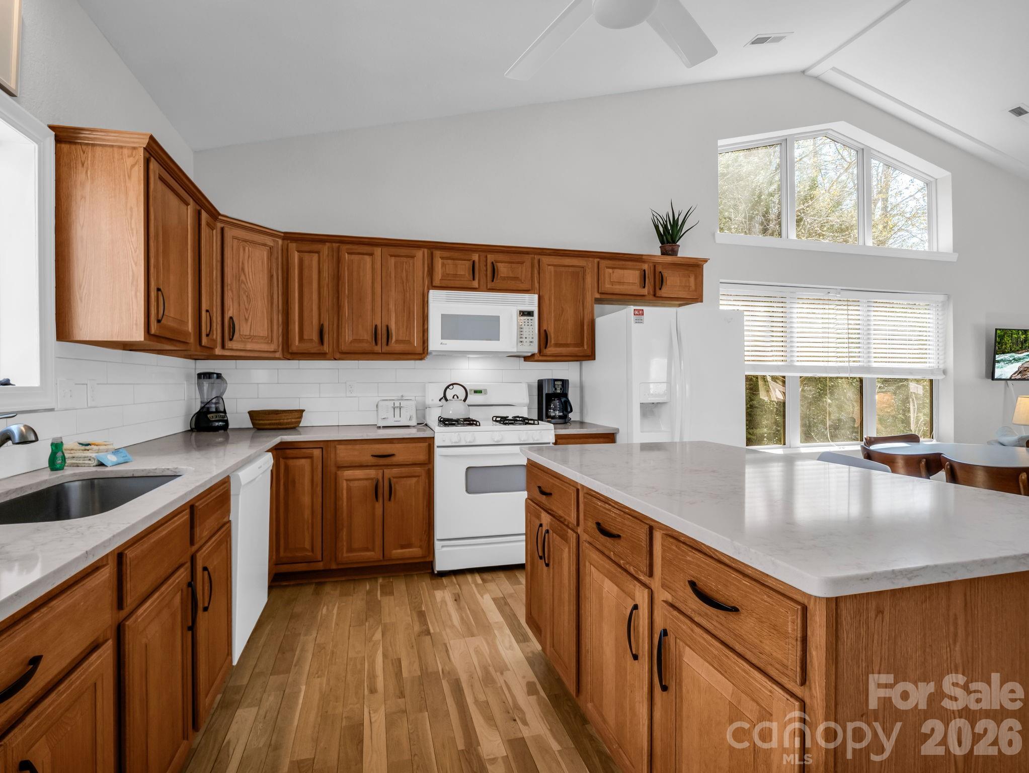 121 Fern Loop Lake Lure, NC 28746 - Photo 26 of 40 a kitchen with granite countertop a sink a counter space appliances and cabinets