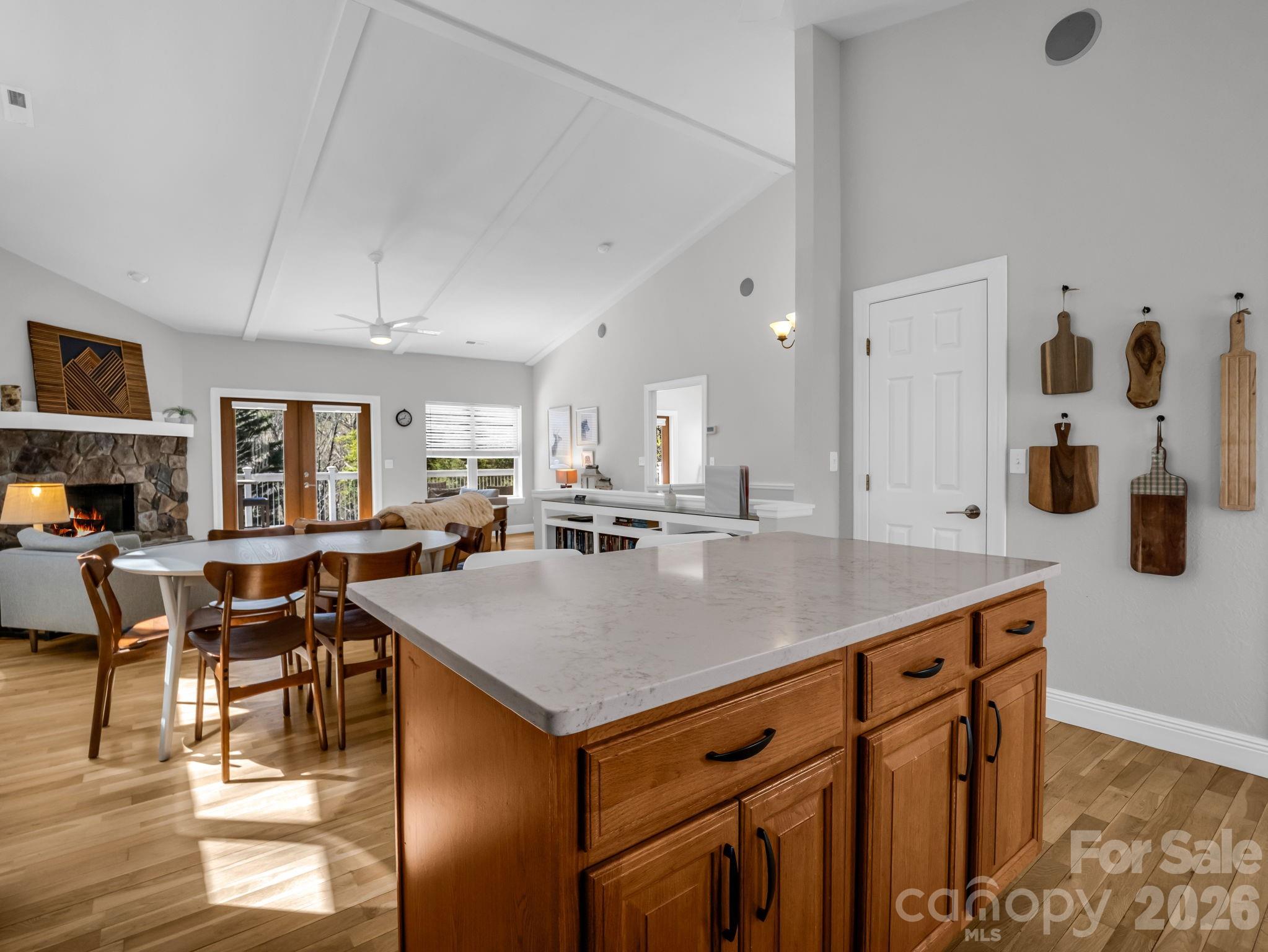 121 Fern Loop Lake Lure, NC 28746 - Photo 28 of 40 a room with stainless steel appliances kitchen island granite countertop a table chairs and a refrigerator