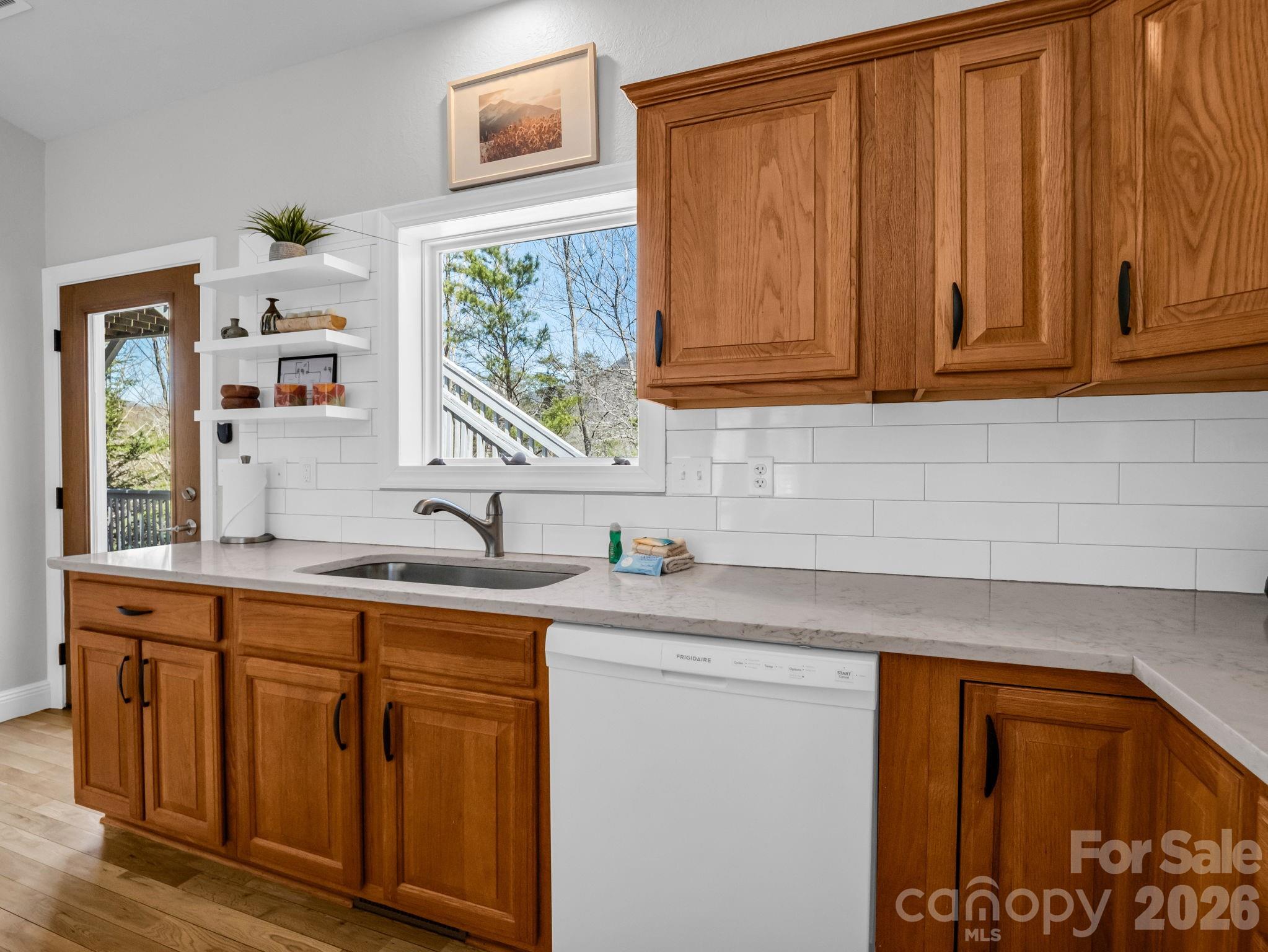 121 Fern Loop Lake Lure, NC 28746 - Photo 29 of 40 a kitchen with stainless steel appliances granite countertop a sink and cabinets