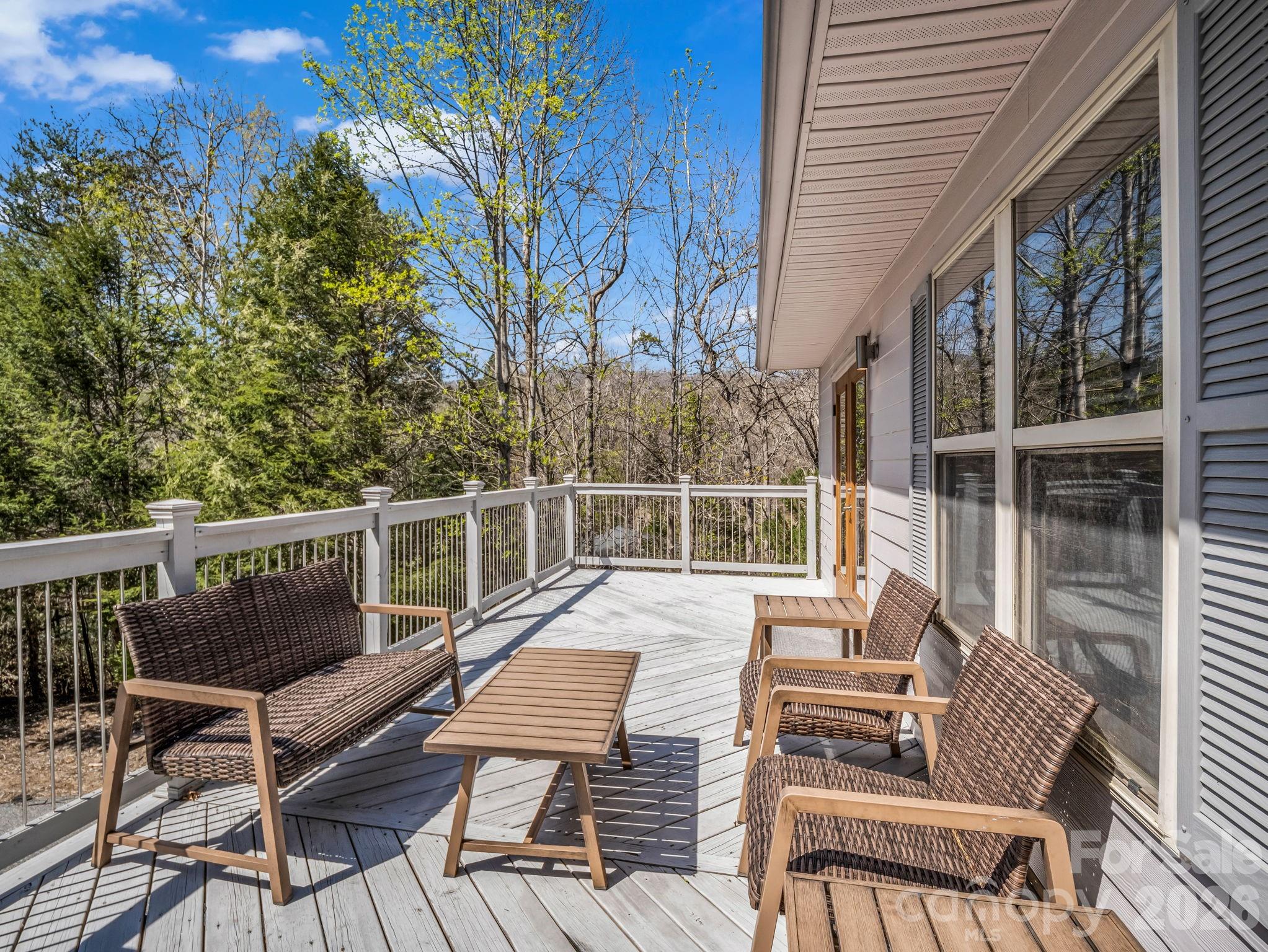 121 Fern Loop Lake Lure, NC 28746 - Photo 6 of 40 a view of balcony with wooden floor and outdoor seating
