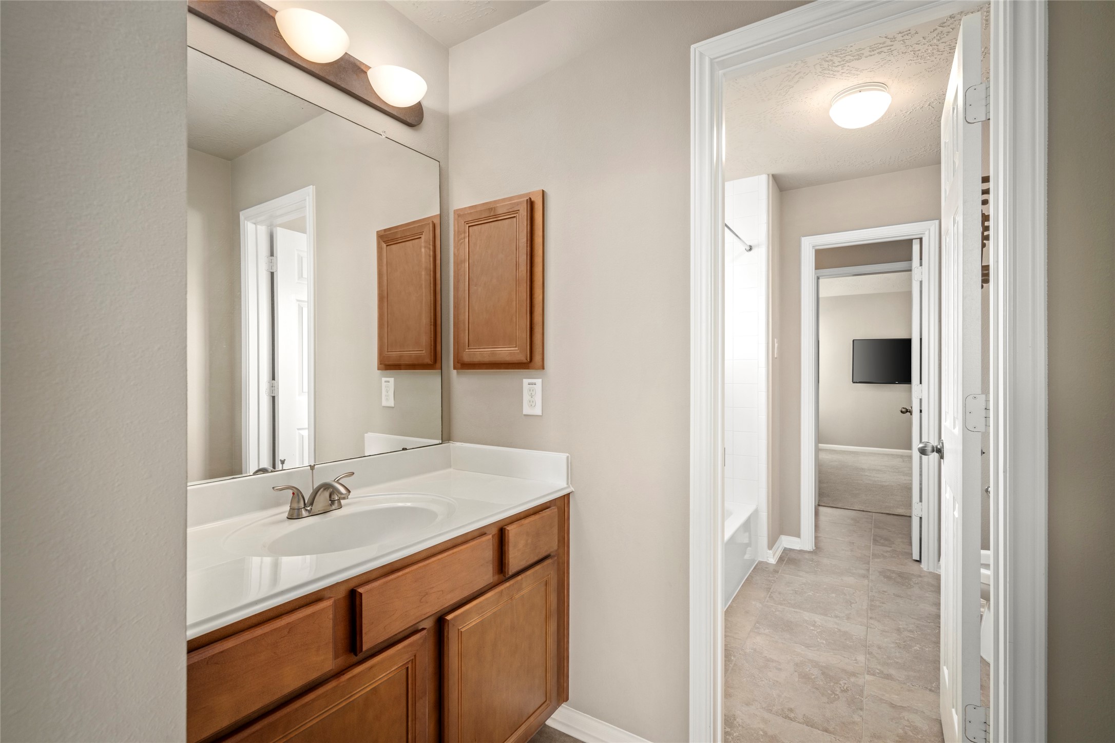 5307 Amber Sky Lane Rosharon, TX 77583 - Photo 39 of 50 A stylish single-sink vanity bath with a large mirror and modern lighting offers convenient access from the upstairs hallway.